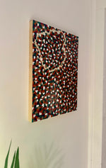 Abstract multicolored patterned artwork on a white wall